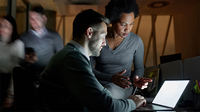 coworkers-viewing-laptop-screen