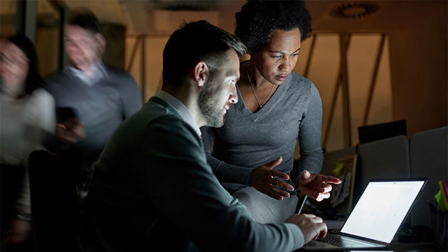 Coworkers Viewing Laptop Screen 