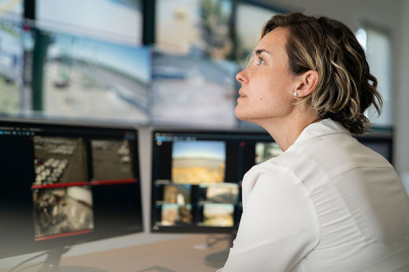 Woman Focused On Multiple Screens 