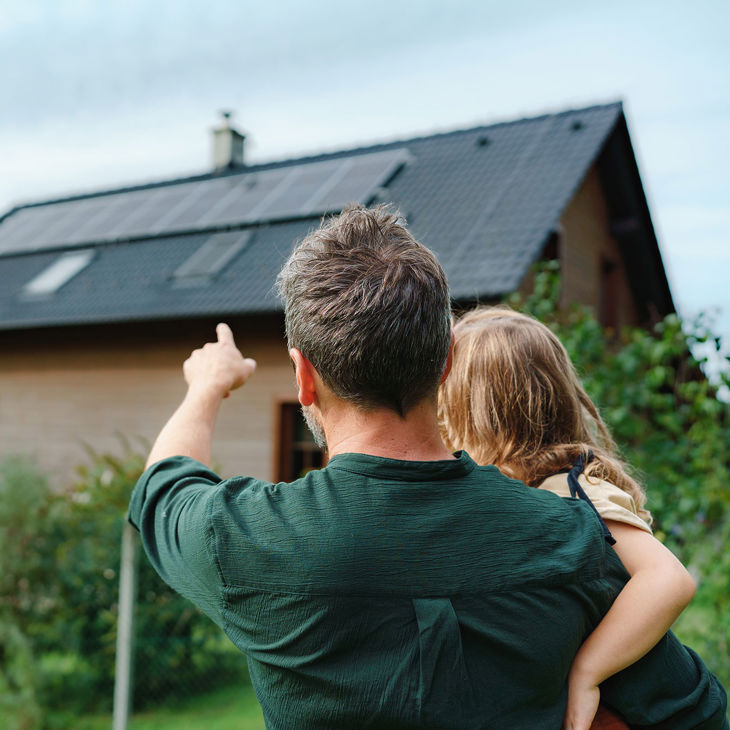 Pointing To Residential Home With Solar Panels 