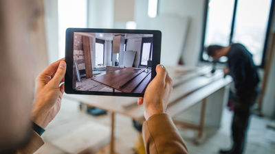 Adjuster Taking Photos Of Interior On Tablet 