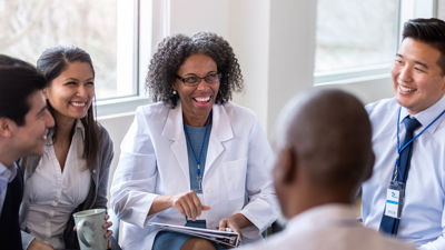 Happy Medical Professionals Speaking In Circle 