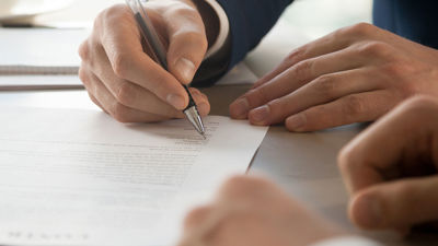 Businesspeople Signing Paper Contract 