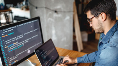 Young Worker Writing Code On Laptop 