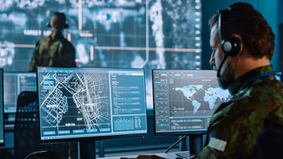 Workers Viewing Coordinates On Multiple Screens 