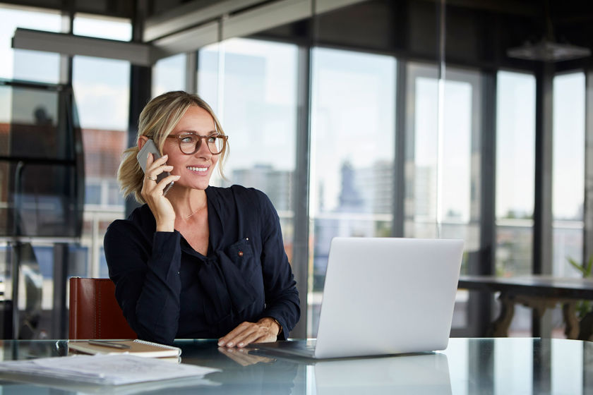 Office Worker Smiling While On The Phone 