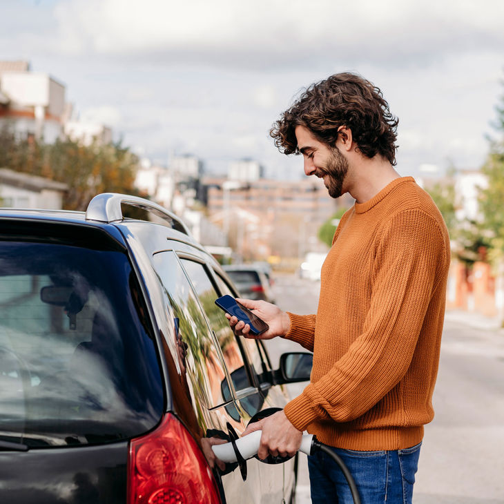 Person Charging Electric Vehicle 