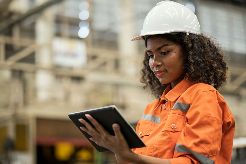Person Viewing Tablet At Construction Site 