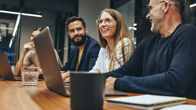 Colleagues Collaborating In Conference Room 