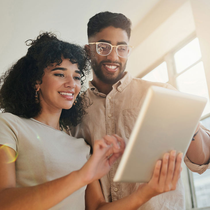 Happy Couple Reviewing Tablet Screen 