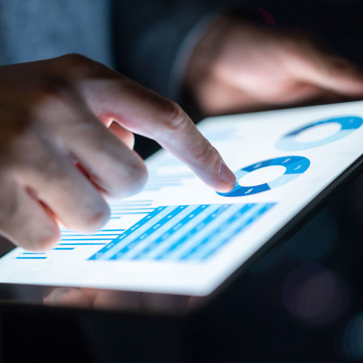 Closeup Of Person Using Tablet With Data 