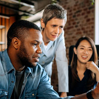 Colleagues Working At Desktop Computer 