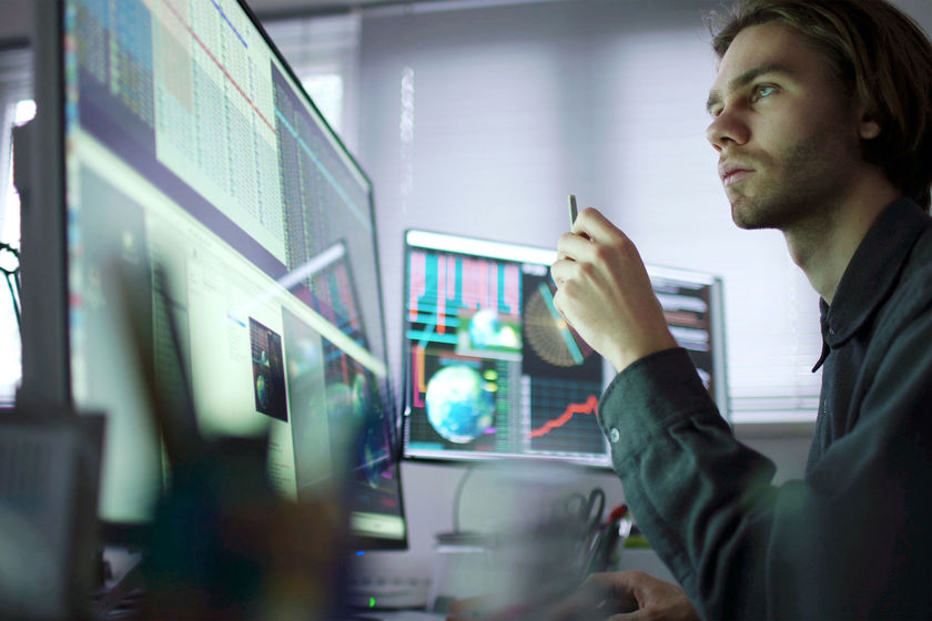 Person Concentrating On Multiple Screens 