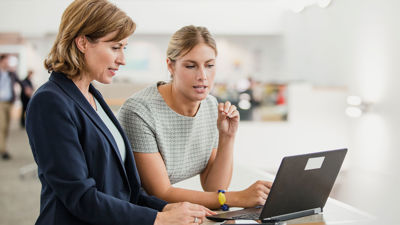 Colleagues Collaborating On Laptop 