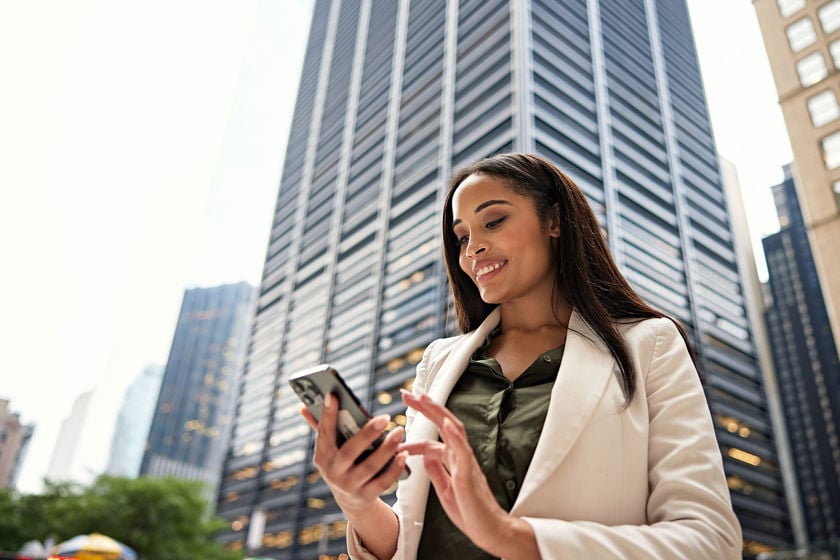 Close Up Of Person Looking Down At Phone Similing 