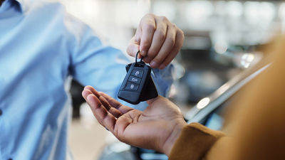 Two People Exchanging Car Key 