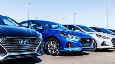 Car Lot With New Sedans In A Row 
