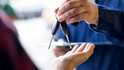 Man Handing Another Man Car Keys 