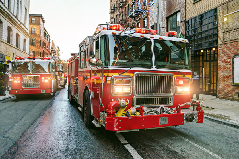 Fire Engines Heading Down City Street 