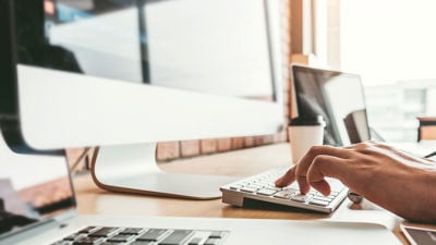 Close Up Of Hands Working At Keyboard 