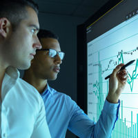 Two Men Reviewing Chart Data 