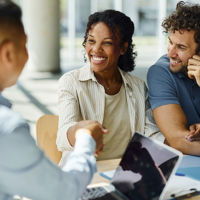 Happy People Shaking Hands At Table 