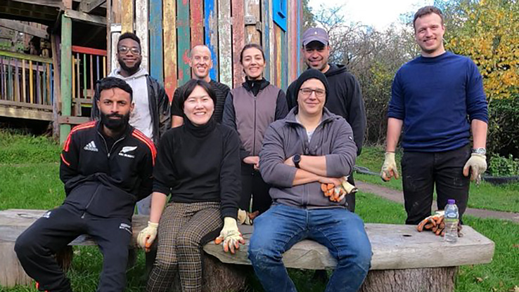 People sitting and standing near bench