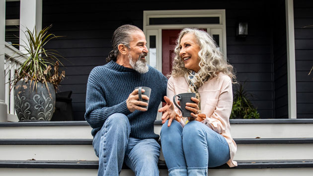 Couple On Porch Sipping Coffee 