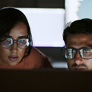 Two Coworkers Reviewing Ai Data 