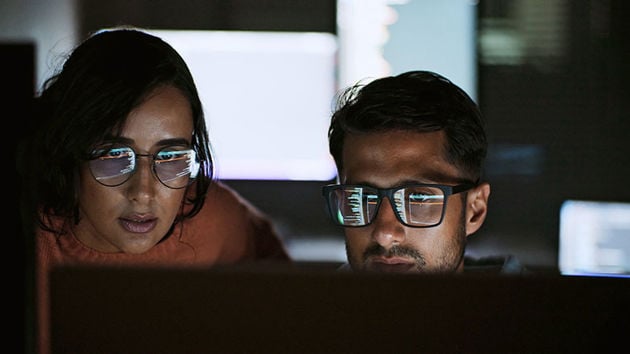 Two Coworkers Reviewing Ai Data 