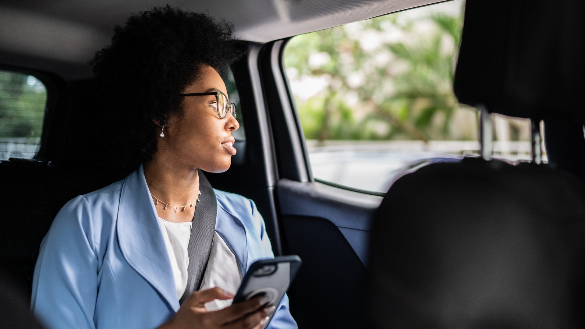 Woman Using Mobile In Taxi 
