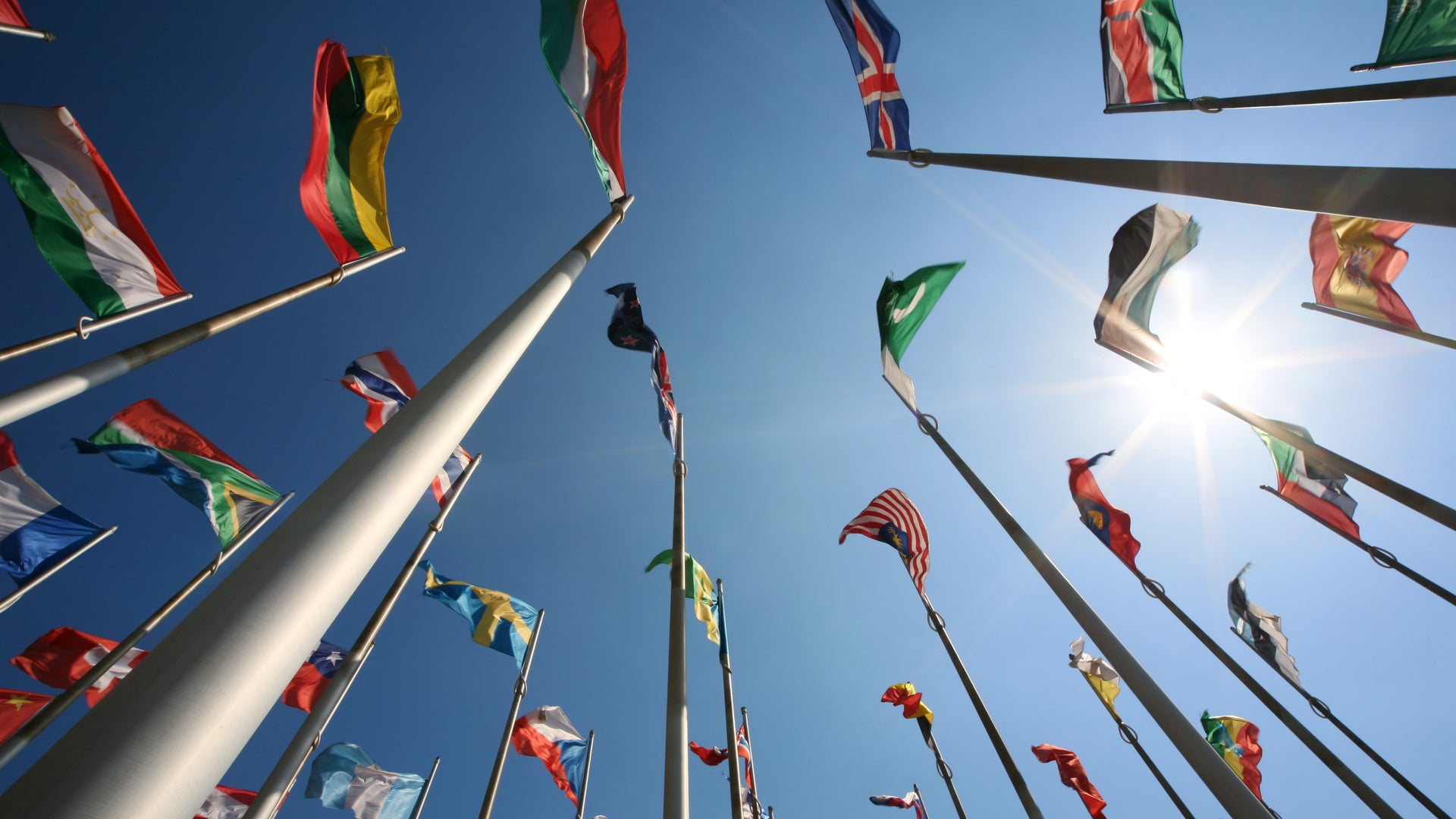 Country Flags Against A Sunny Blue Sky 