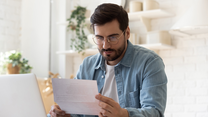 person-reviewing-document-at-desk