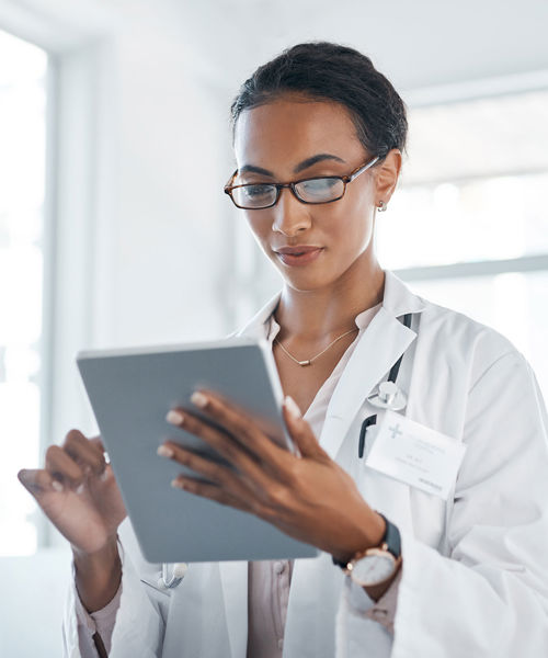 Doctor Reviewing Info On Tablet 
