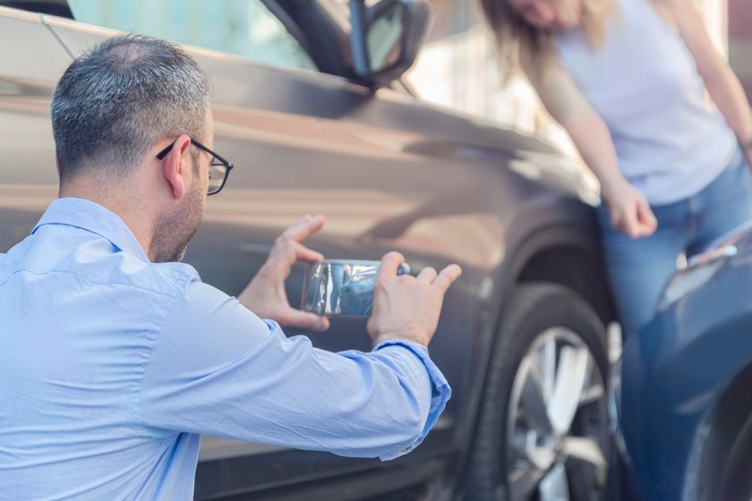 Man Taking Photo Of Car Damage With Mobile 