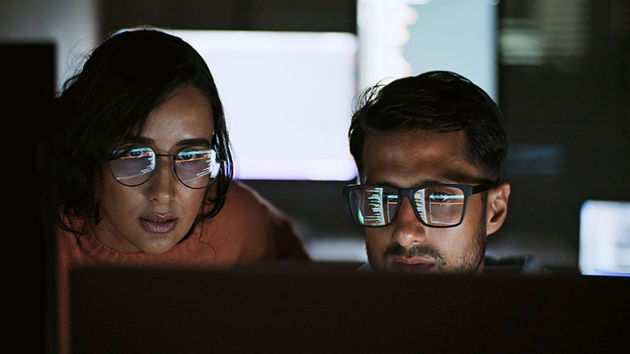 Two Coworkers Reviewing Ai Data 