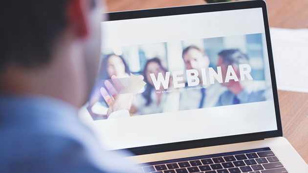 Man Looking At Webinar Screen On Laptop 
