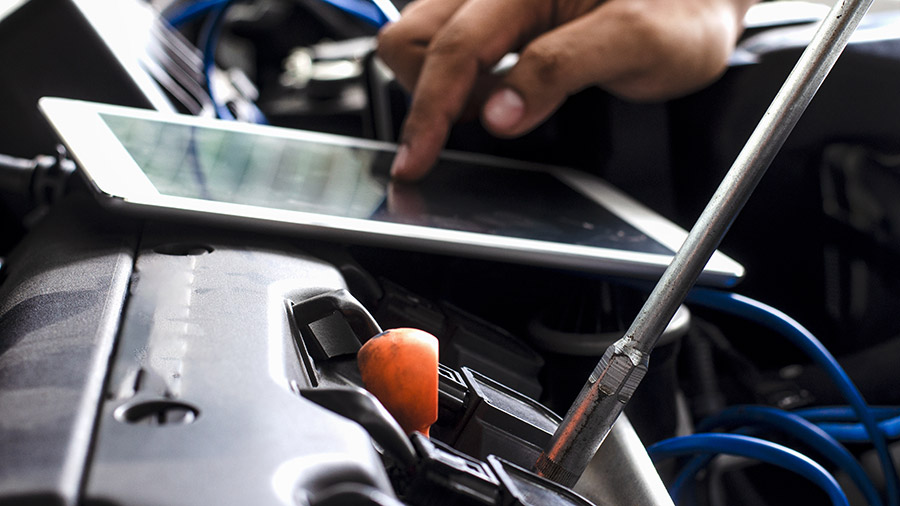 mechanic-running-engine-diagnostics-on-tablet