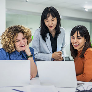 Coworkers Reviewing Data On Laptop Screens 