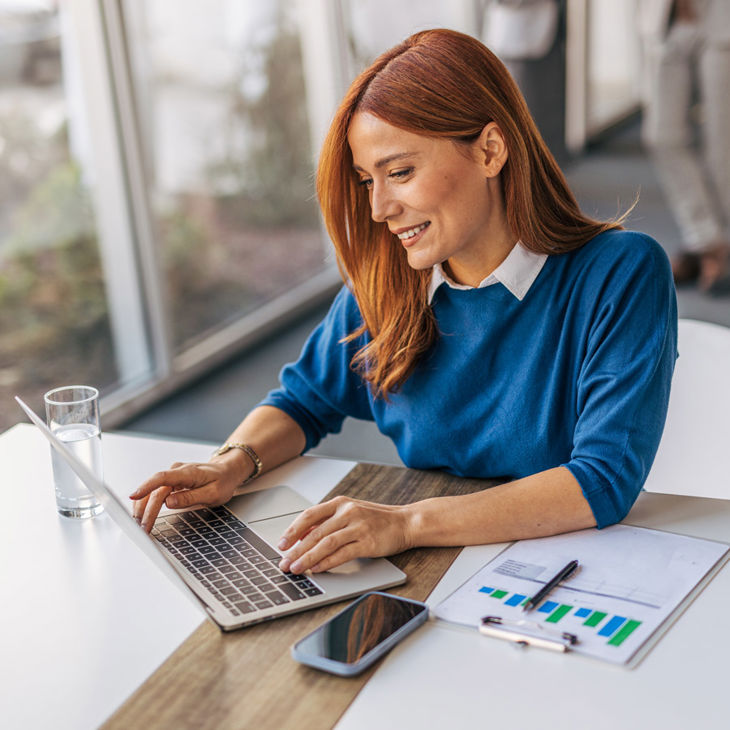Woman At Desk Working On Laptop 