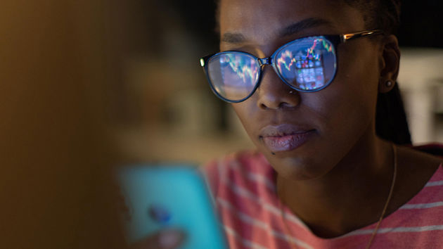 Woman Reviewing Mobile Phone Screen 