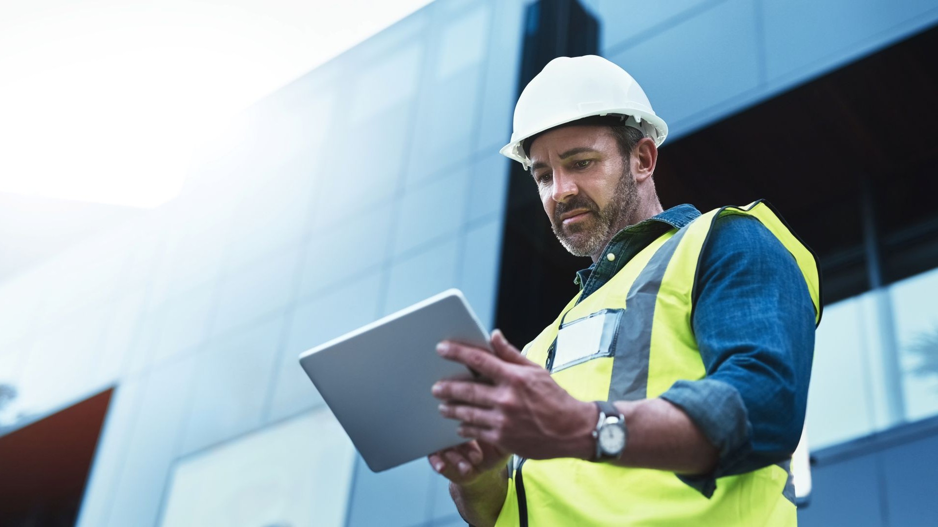 Man Looking At Tablet With Hardhat Vest Construction 