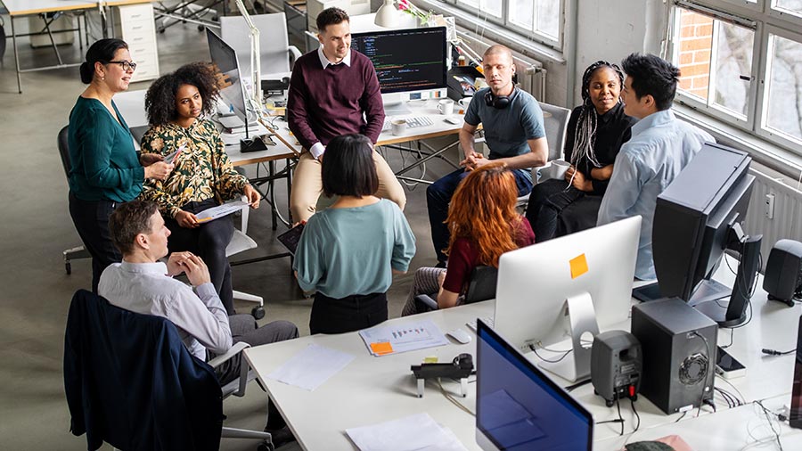group-of-coworkers-meeting-between-desks