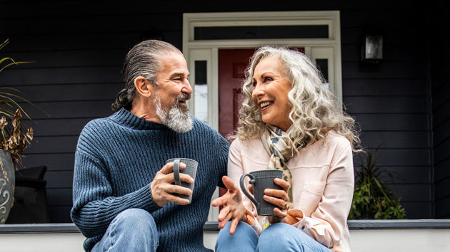 Couple On Porch Sipping Coffee 