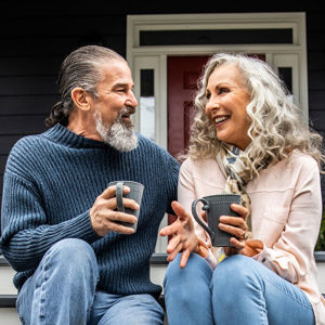 Couple On Porch Sipping Coffee 