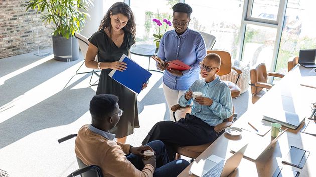 Coworkers Meeting At A Desk 