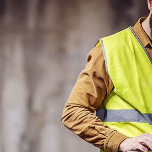 Construction Worker In Viewing Laptop At Jobsite 