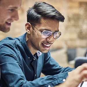 Coworkers Viewing Data On Laptop Screen 