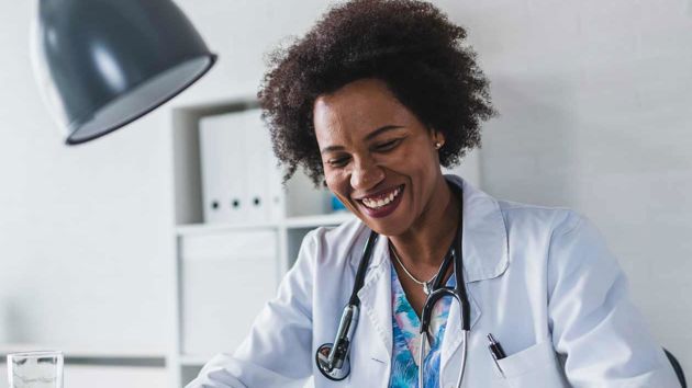 Doctor Reviewing Records On A Tablet 