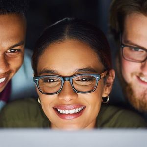 Coworkers Reviewing Data On Computer Monitor 